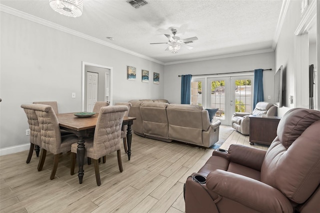 3611 19th St N, Saint Petersburg, FL 33713 - dining room with light wood-style floors, a ceiling fan, a textured ceiling, ornamental molding, and french doors