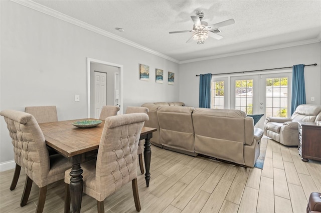 3611 19th St N, Saint Petersburg, FL 33713 - dining room featuring a ceiling fan, light wood-style flooring, crown molding, and a textured ceiling