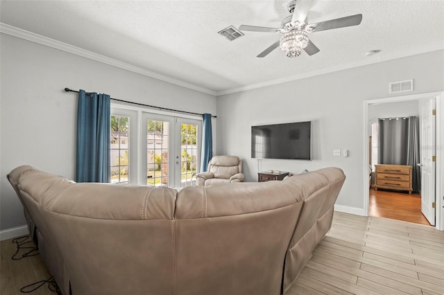 3611 19th St N, Saint Petersburg, FL 33713 - living area featuring a ceiling fan, ornamental molding, light wood finished floors, a textured ceiling, and baseboards