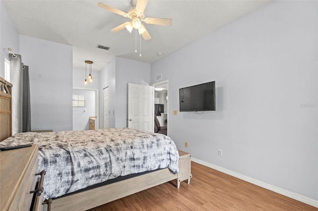 3611 19th St N, Saint Petersburg, FL 33713 - bedroom featuring baseboards, wood finished floors, ensuite bathroom, and a ceiling fan