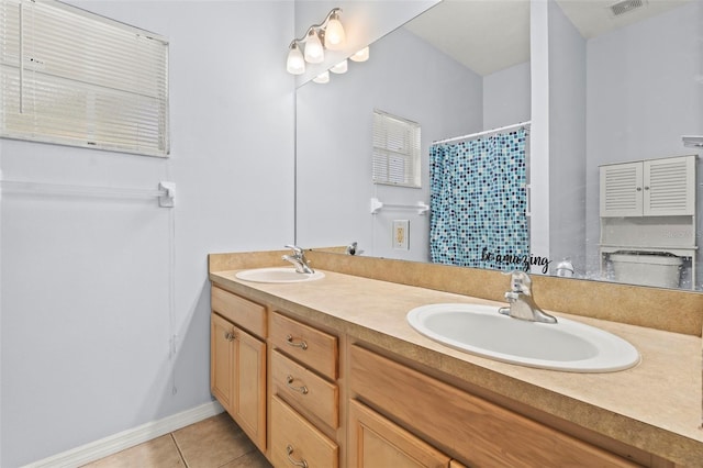 3611 19th St N, Saint Petersburg, FL 33713 - bathroom with double vanity, tile patterned flooring, a shower with shower curtain, and baseboards