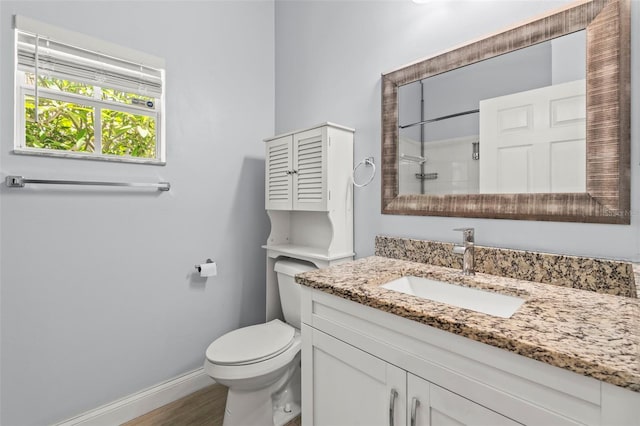 3611 19th St N, Saint Petersburg, FL 33713 - full bath featuring vanity, toilet, baseboards, a shower, and wood finished floors