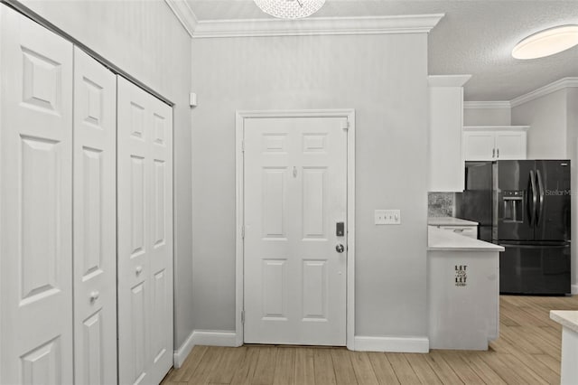 3611 19th St N, Saint Petersburg, FL 33713 - foyer with light wood-style flooring, ornamental molding, baseboards, and a textured ceiling