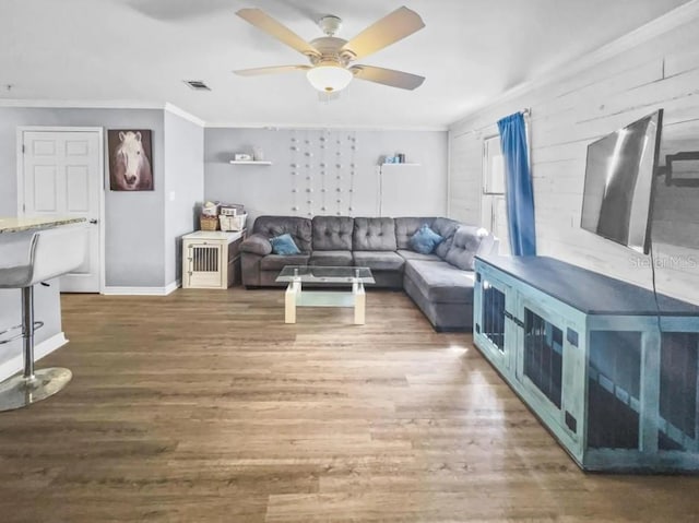 living room with ceiling fan, dark hardwood / wood-style flooring, and ornamental molding