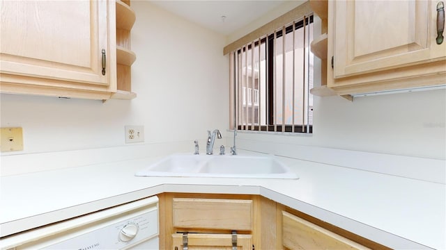 kitchen featuring white dishwasher, light brown cabinets, and sink