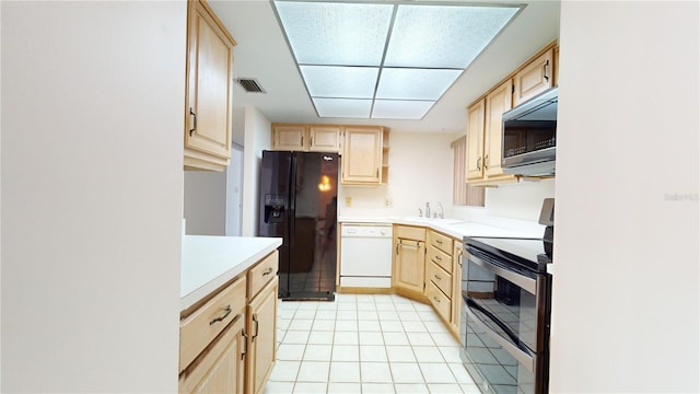 kitchen with light tile patterned flooring, light brown cabinetry, sink, and black appliances