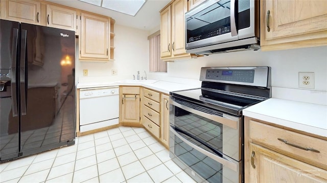 kitchen featuring sink, light brown cabinets, light tile patterned flooring, and stainless steel appliances