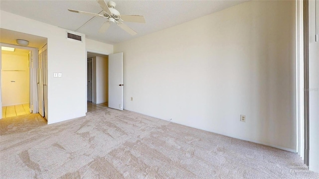 unfurnished bedroom with ceiling fan and light colored carpet