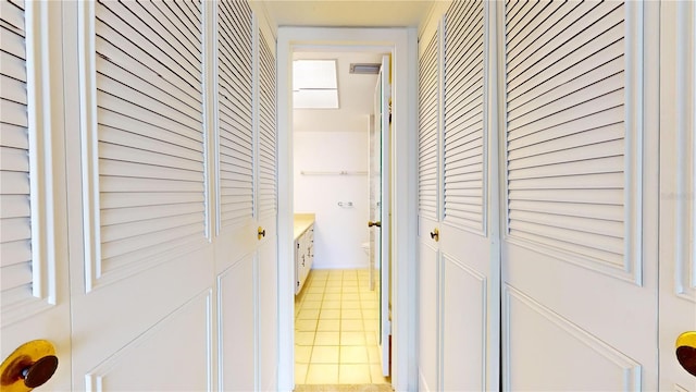 laundry area featuring light tile patterned flooring