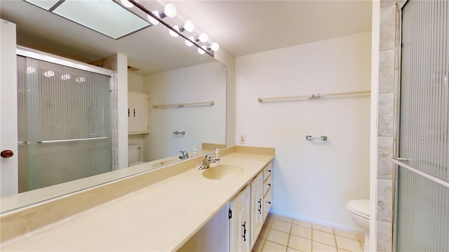 bathroom with tile patterned floors, vanity, toilet, and an enclosed shower