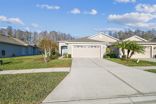 ranch-style home with a garage and a front lawn