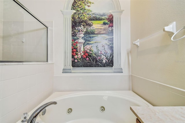 bathroom featuring vanity and tiled bath