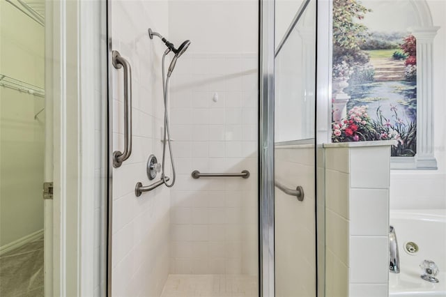 bathroom with a shower with door