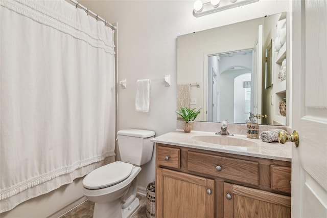 full bathroom with tile patterned floors, shower / bath combo with shower curtain, vanity, and toilet