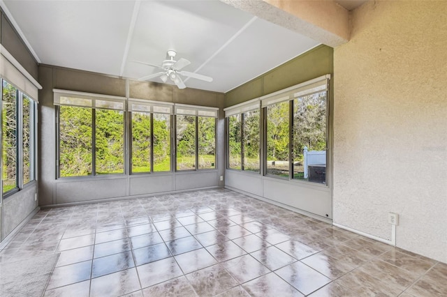 unfurnished sunroom featuring ceiling fan