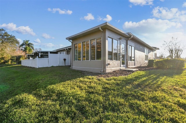 view of home's exterior with a lawn