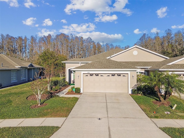 ranch-style home with a garage and a front lawn