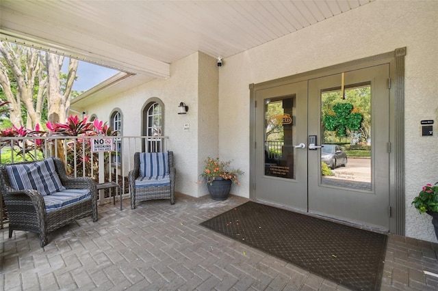 view of exterior entry featuring french doors