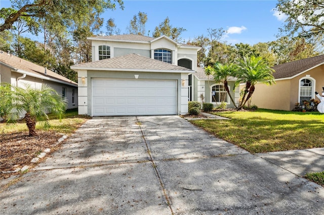 view of property with a front lawn and a garage