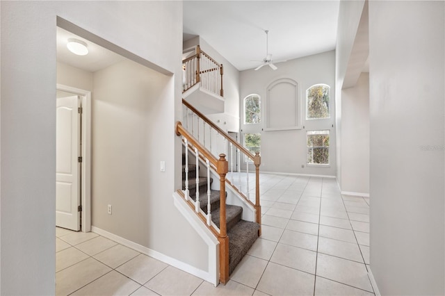 entrance foyer with ceiling fan and light tile patterned flooring