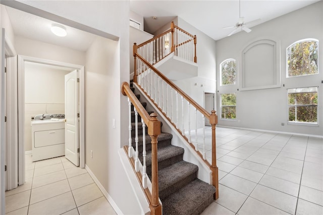 staircase featuring ceiling fan, tile patterned flooring, and washer / dryer