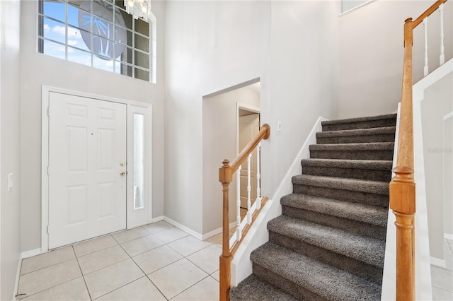 foyer featuring tile patterned floors and a high ceiling