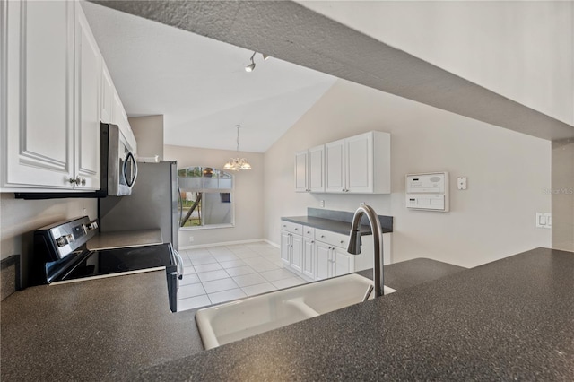 kitchen featuring white cabinets, range with electric stovetop, light tile patterned flooring, and sink