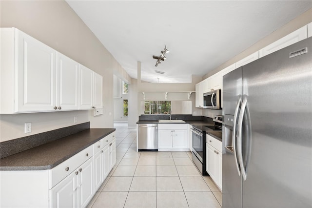 kitchen featuring white cabinets, stainless steel appliances, and kitchen peninsula