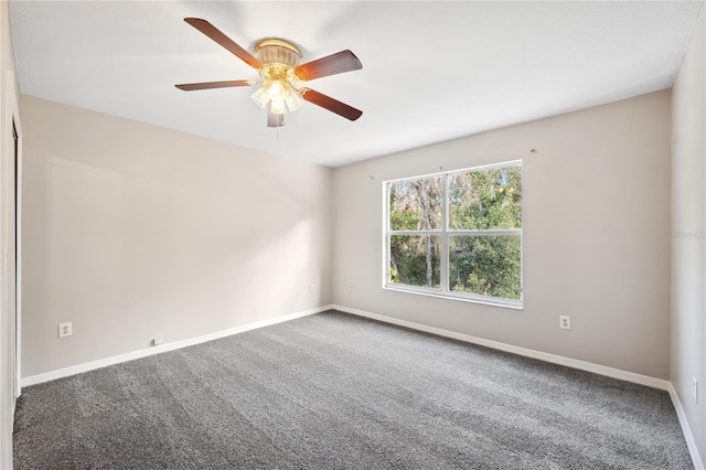 spare room featuring carpet and ceiling fan