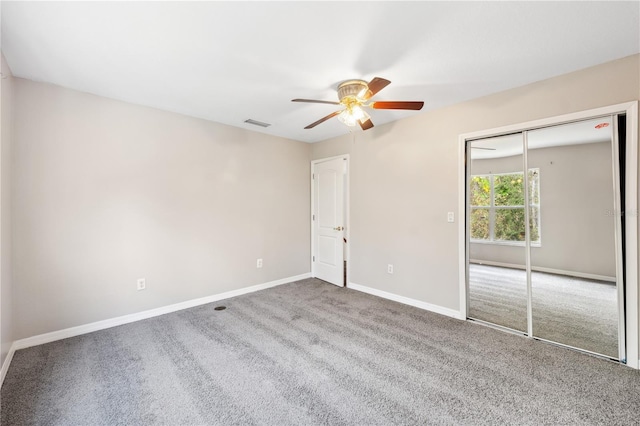 unfurnished bedroom featuring carpet flooring, a closet, and ceiling fan