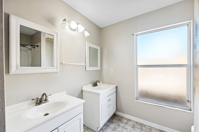 bathroom with vanity, a healthy amount of sunlight, and walk in shower