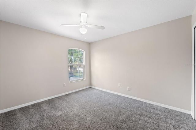 spare room featuring ceiling fan and carpet floors