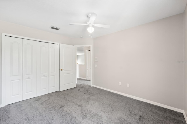 unfurnished bedroom featuring carpet, ceiling fan, and a closet