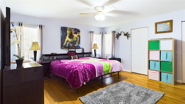 bedroom featuring wood-type flooring, a closet, and ceiling fan