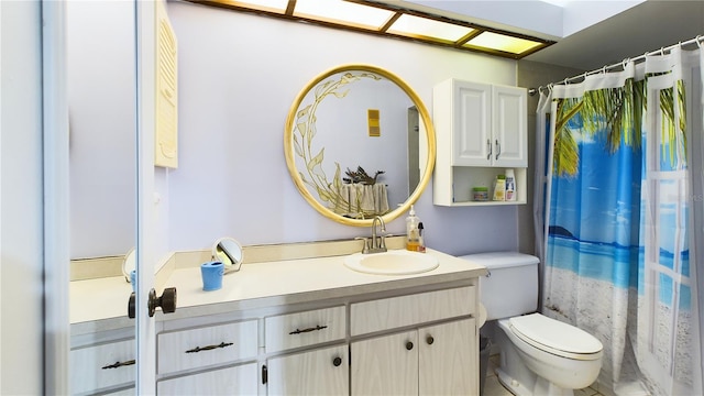 bathroom with walk in shower, vanity, and toilet