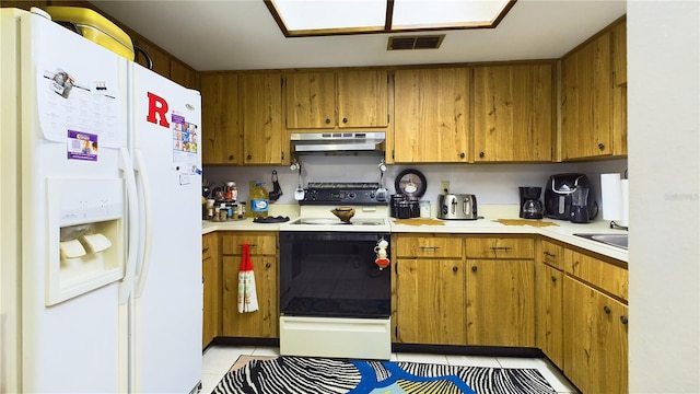 kitchen with sink, white appliances, and light tile patterned flooring