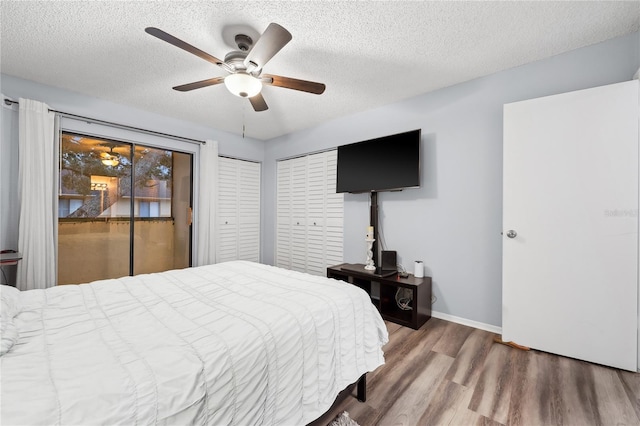 bedroom featuring ceiling fan, a textured ceiling, hardwood / wood-style flooring, and access to outside