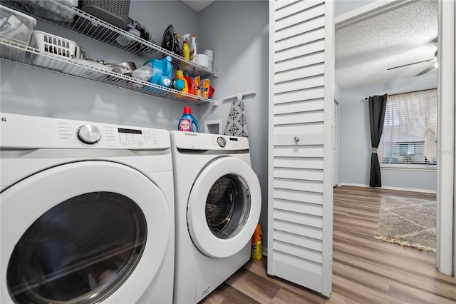 clothes washing area featuring washer and clothes dryer, a textured ceiling, and hardwood / wood-style floors