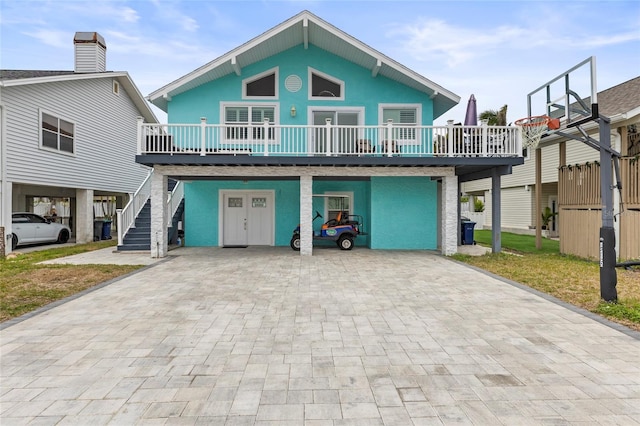 beach home with a deck and a carport