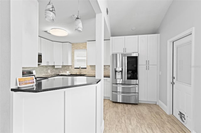 kitchen with white cabinetry, pendant lighting, and appliances with stainless steel finishes