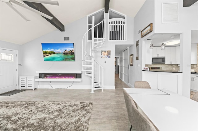 living room with hardwood / wood-style floors and lofted ceiling with beams