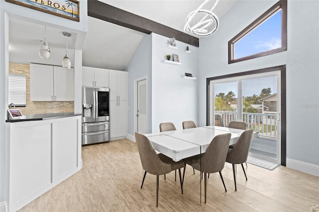 dining area featuring beamed ceiling, a chandelier, and light hardwood / wood-style flooring