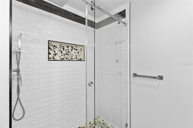 bathroom featuring a shower with door