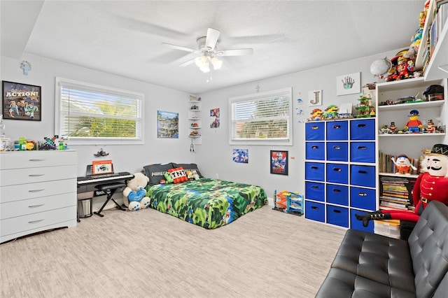 bedroom with ceiling fan and a textured ceiling