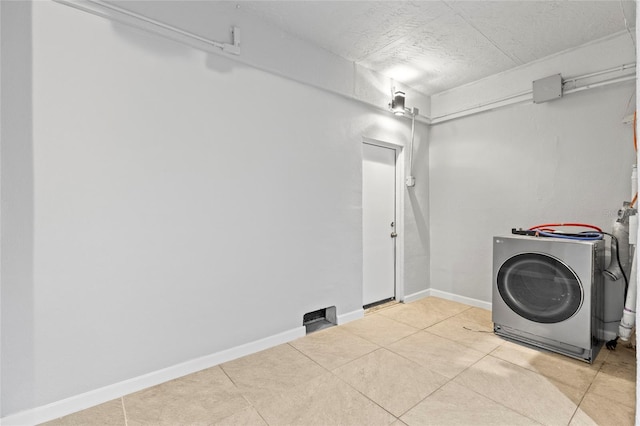 laundry room featuring light tile patterned flooring and washer / dryer