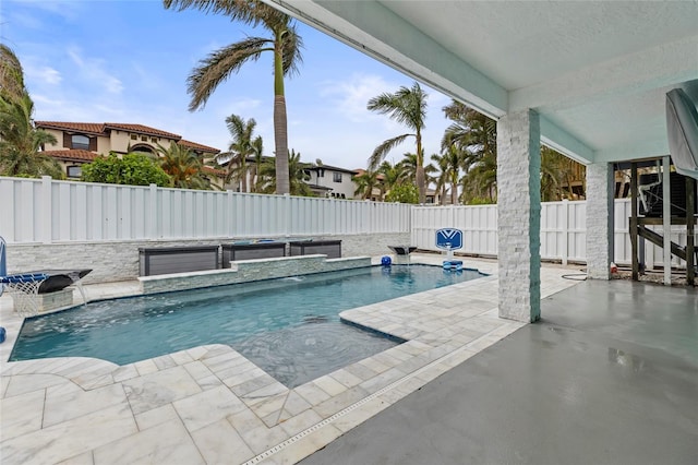 view of swimming pool with a patio area, pool water feature, and a jacuzzi