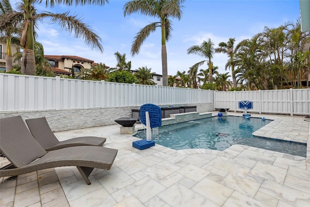 view of pool featuring pool water feature, a hot tub, and a patio area