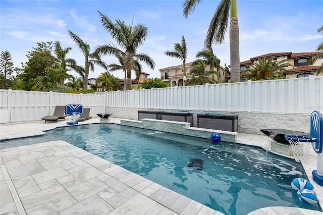 view of swimming pool featuring pool water feature and a patio area