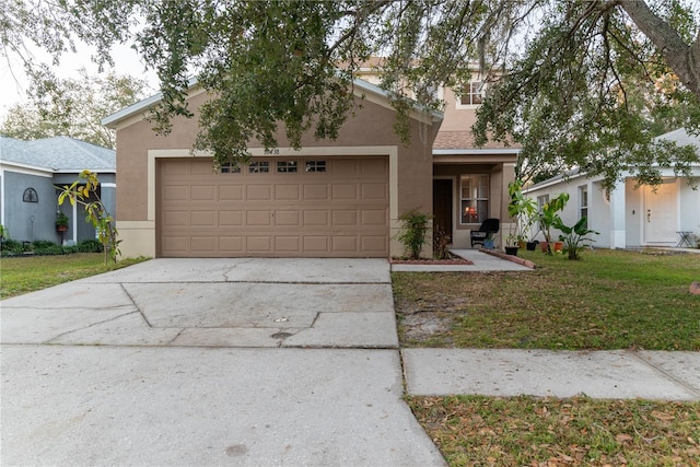 view of front of house featuring a garage and a front lawn