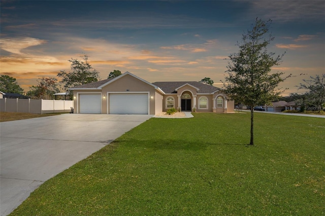 ranch-style house with a lawn and a garage